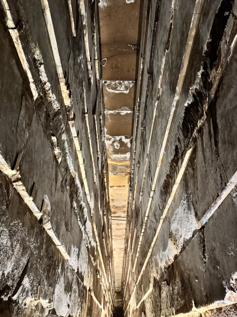 The steep, narrow Grand Gallery inside the Great Pyramid, lit from within.