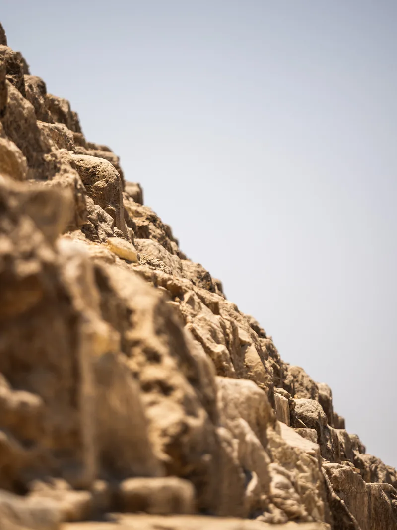 Close view of weathered pyramid blocks climbing steeply out of frame.