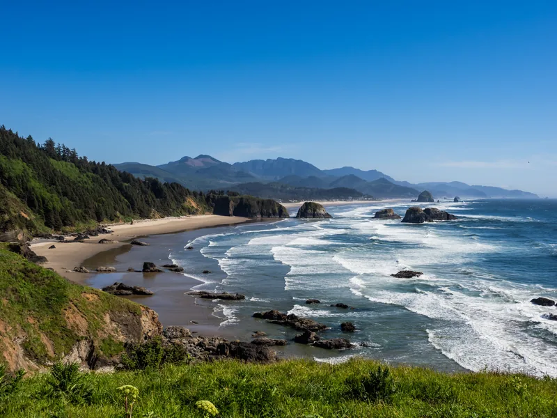 The Oregon coastline from Ecola State Park, with green headlands and surf.