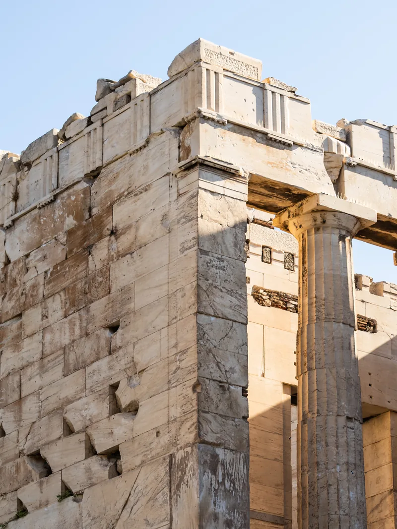 The weathered marble corner and columns of the Propylaea on the Acropolis.