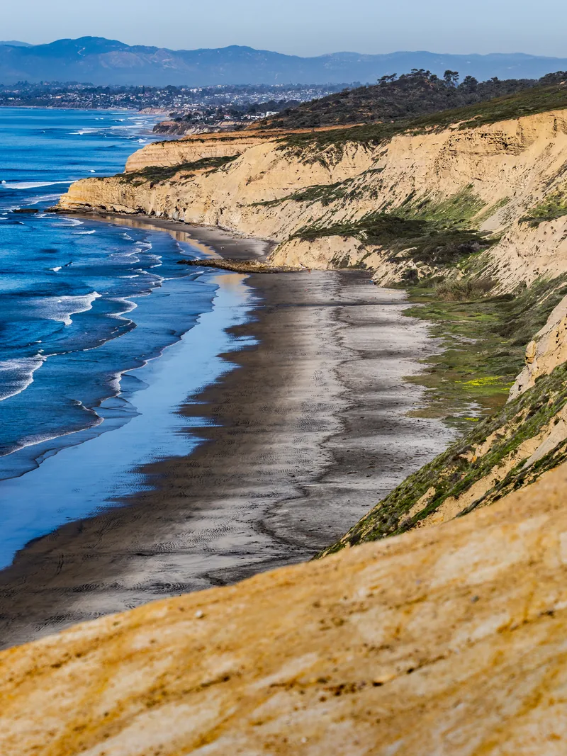 Sandstone cliffs curving along Black's Beach far below.