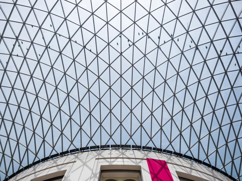 The glass-and-steel lattice roof of the British Museum's Great Court, curving up from the Reading Room.