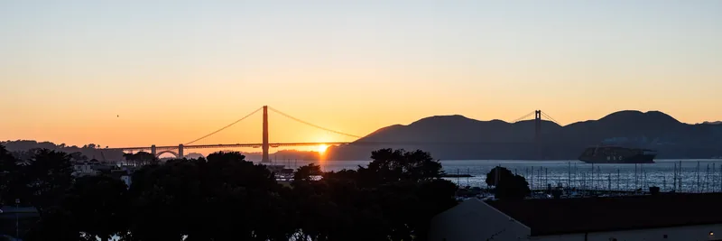 The Golden Gate Bridge and Marin Headlands silhouetted at sunset.