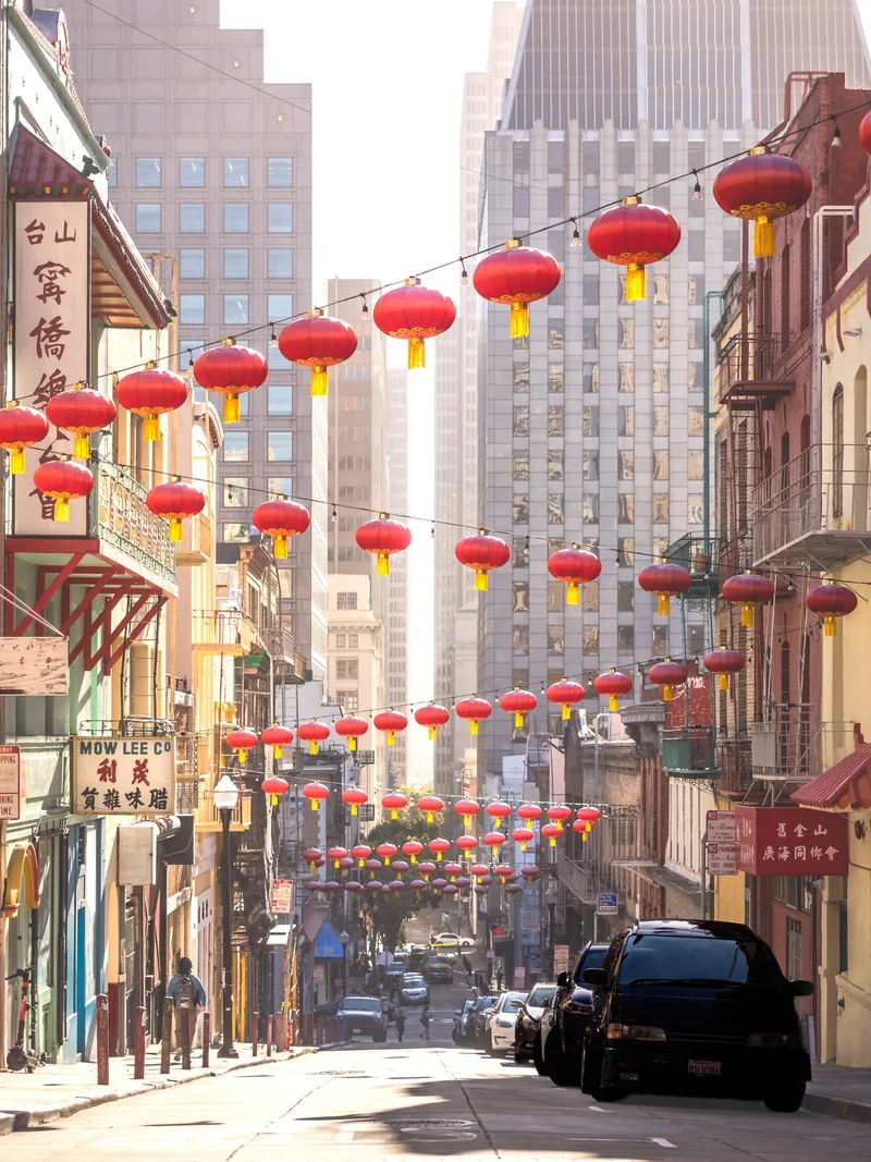 Red lanterns strung high above a Chinatown street.