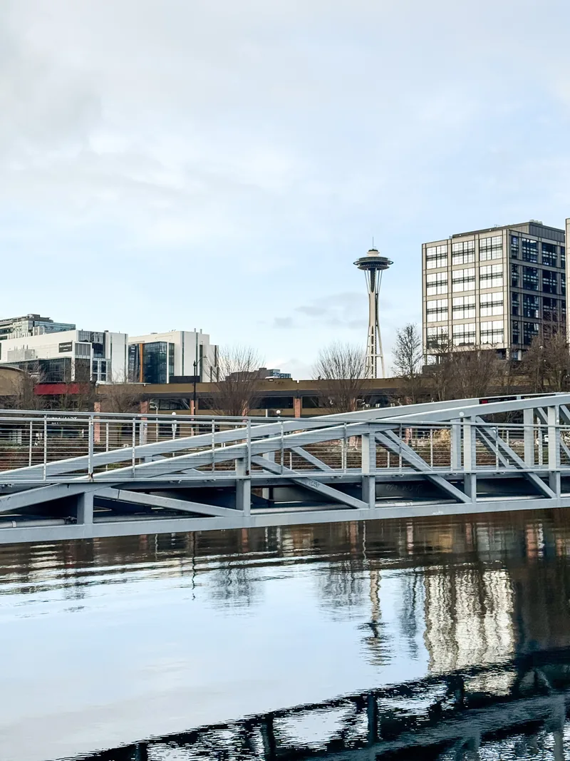The Space Needle rising behind a dock ramp and buildings on Lake Union.