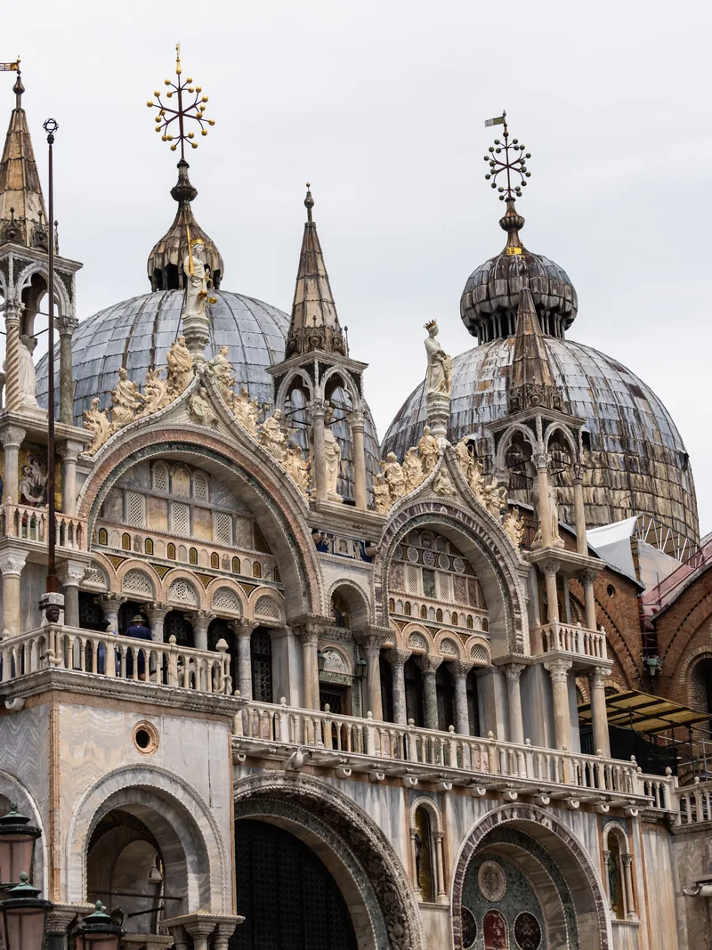 The domes, spires and carved arches of St Mark's Basilica.